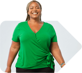 Woman wearing green shirt standing and smiling.